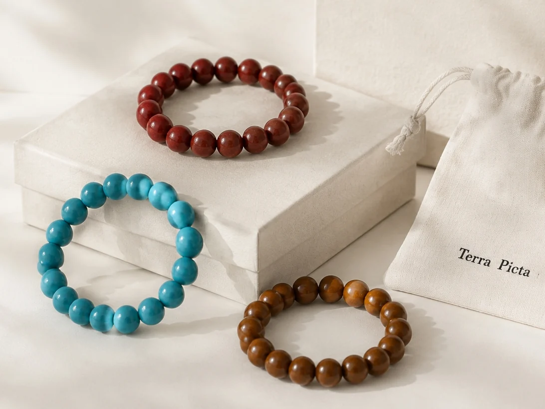 Terra Picta red, turquoise, and warm brown aroma bracelets with a linen pouch